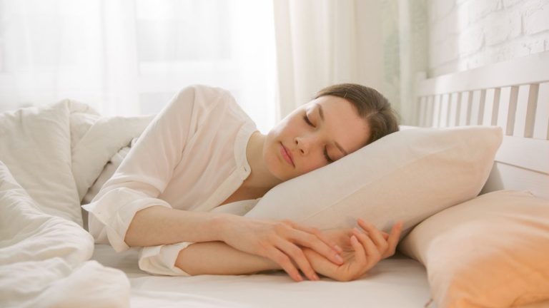 Woman resting peacefully in bed