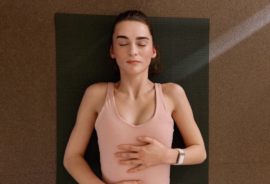 WHOOP 5.0 fitness tracker worn on the wrist during a recovery session